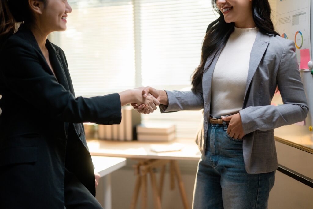 Businesswomen shaking hands closing a deal and ac 2026 03 24 07 07 38 utc pichi