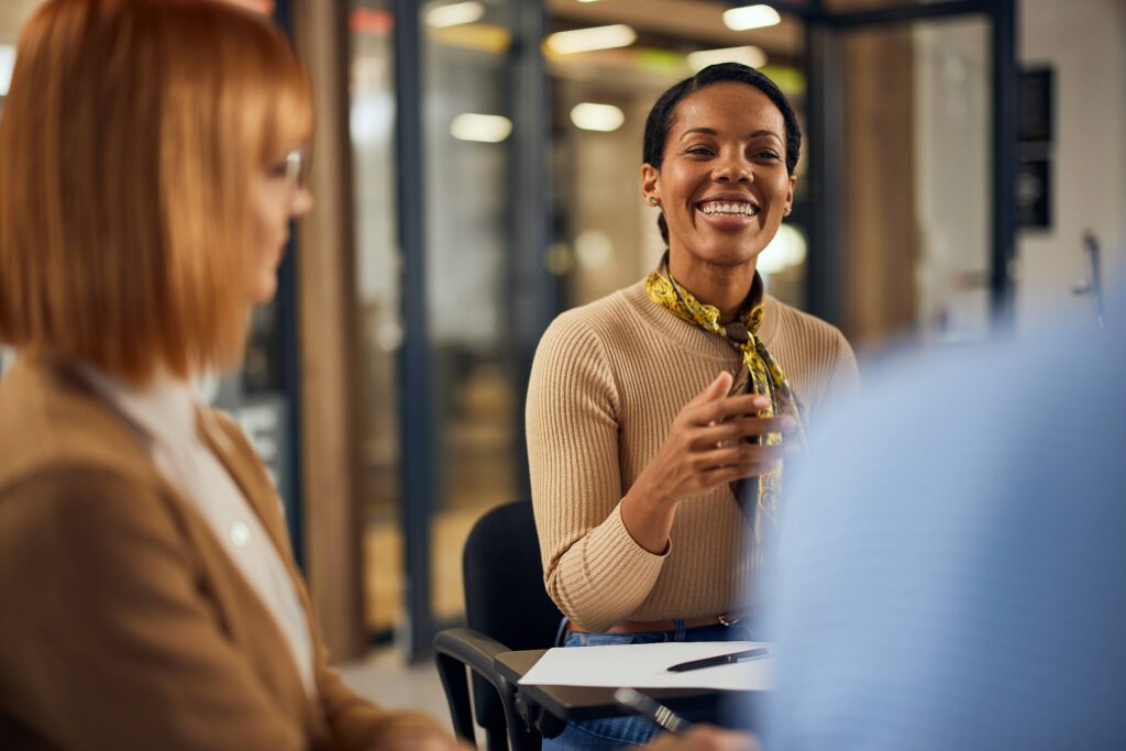 Focus on the smiling african woman talking to oth 2026 03 20 04 15 52 utc pichi